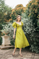 Silk midi dress with puff sleeves, sweetheart neckline, and fitted waist detail